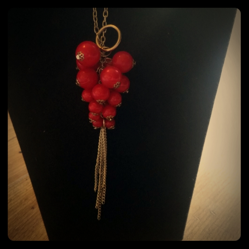 Long necklace with red beads and matching earrings